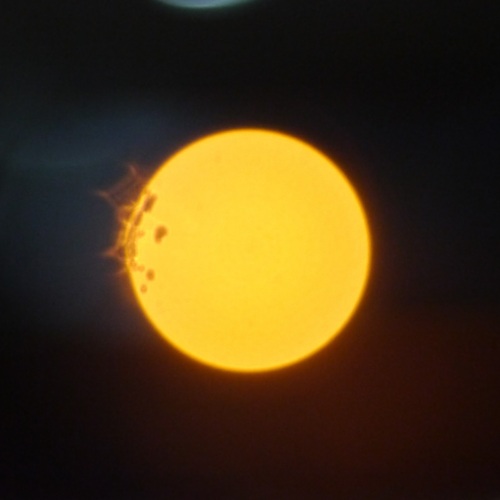 Spot light is about 200m away, focus set at 0.45m, aperture f/1.8. ISO 1600, 1/40s. The bokeh dimension is about 1000x1000 pixels, that is a little more than a fifth of the width of the image.