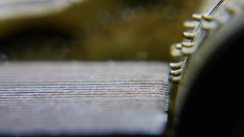 Sample frame from the video (near the start, the wheel is not moving yet). Some chromatic aberration can be seen (especially on the teeth of the wheel at the top right), and the white balance is clearly off.