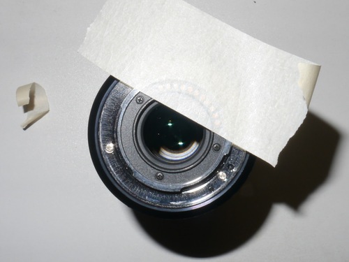 Masking tape applied to lens contacts area.