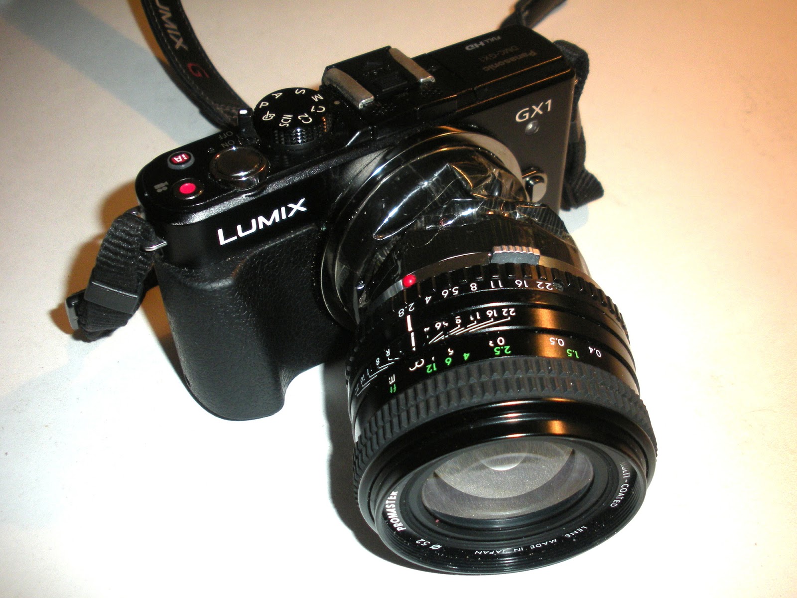 Lens and adapter mounted on the camera.